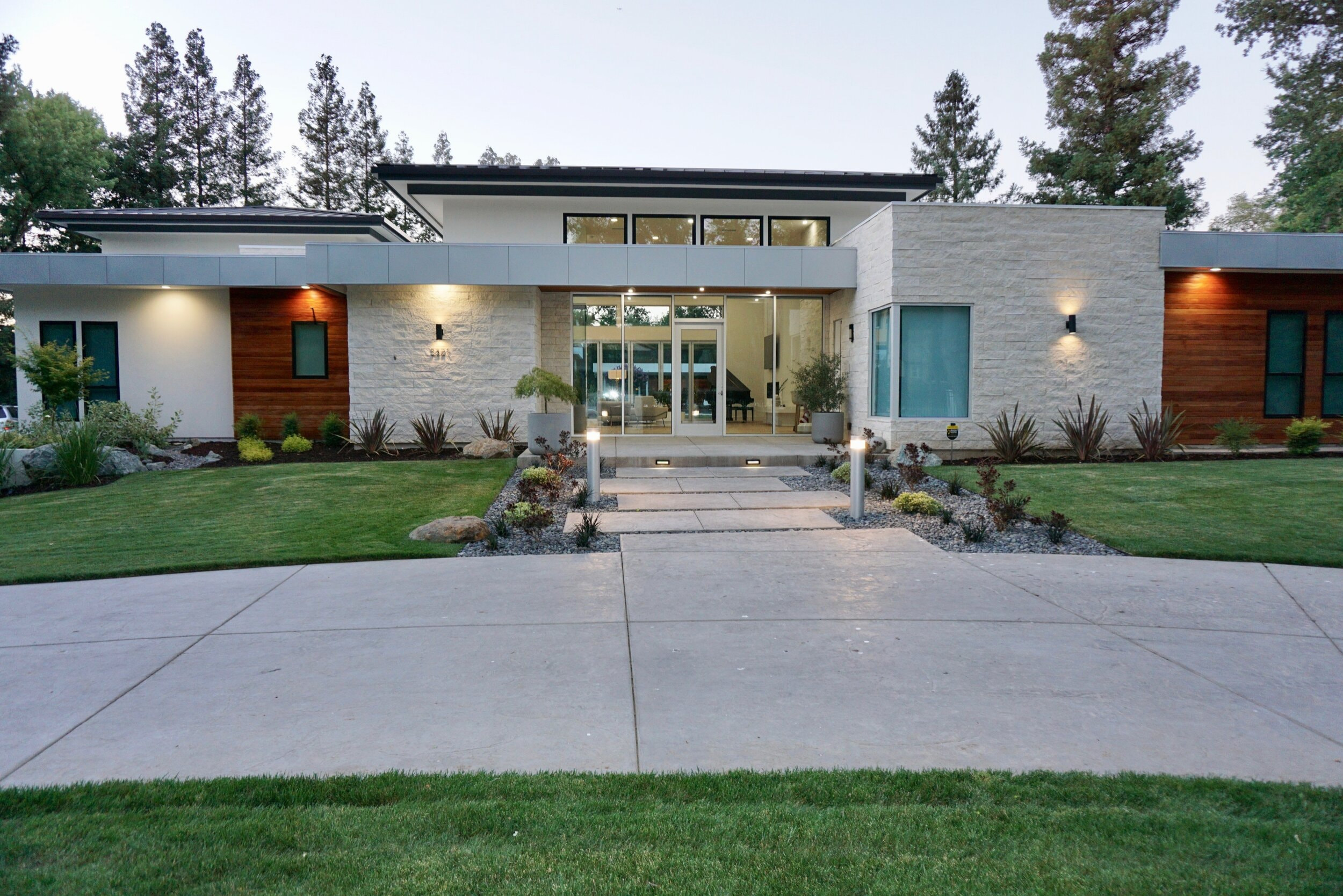 Modern Arden Project exterior with an illuminated glass entry