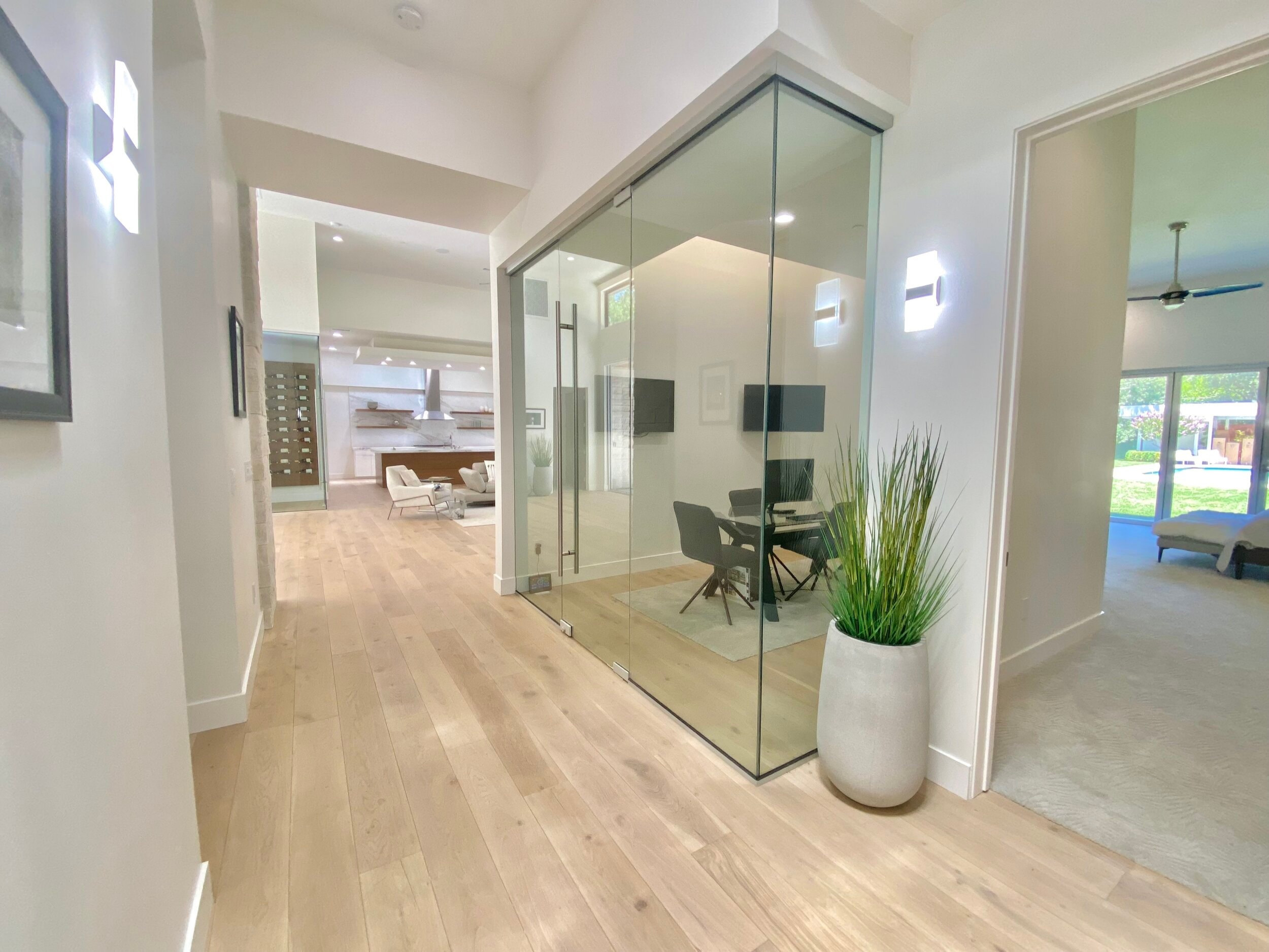 Glass-enclosed home office opening onto the main hallway