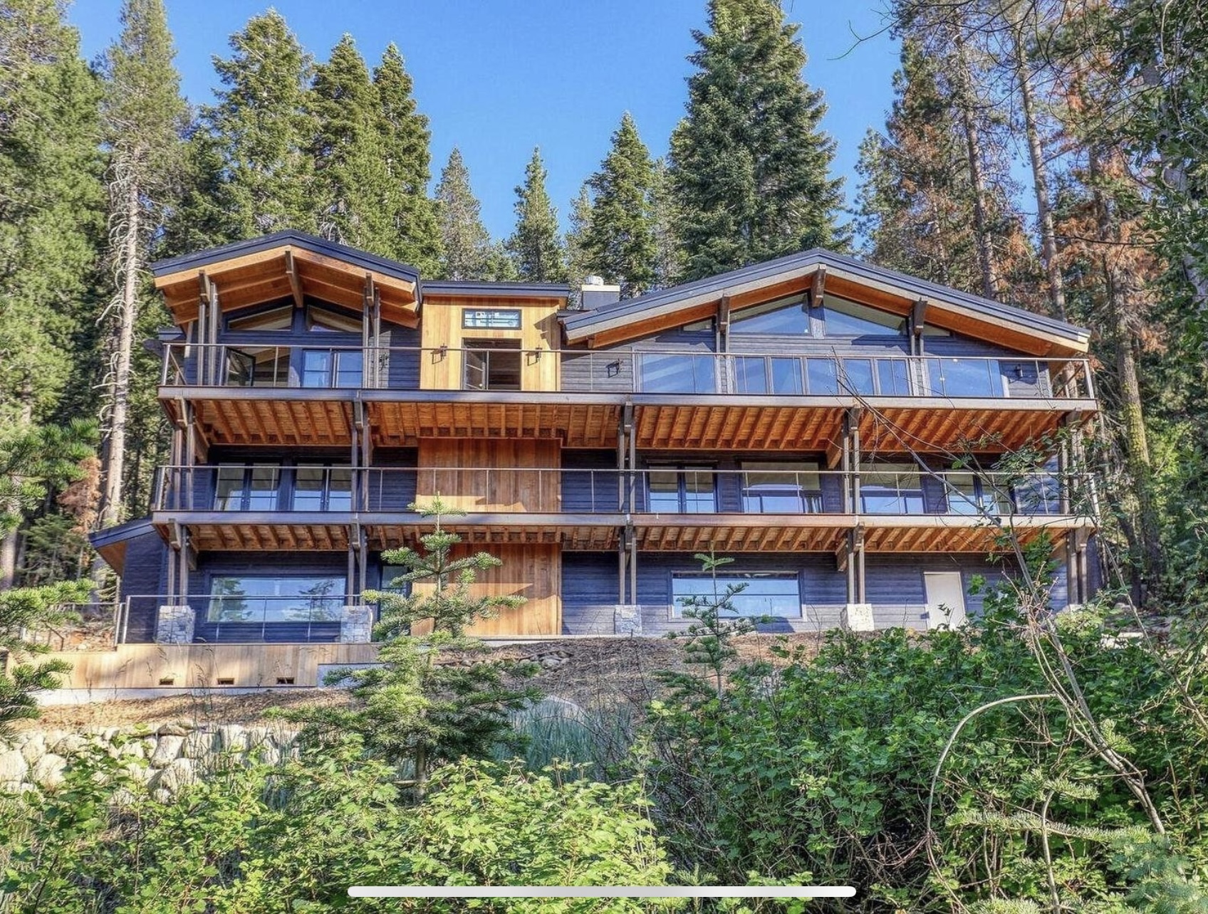 Donner Residence set among pines with broad timber decks