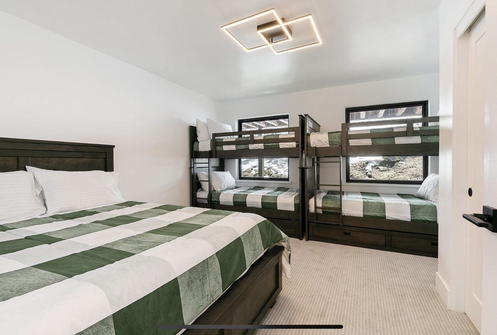 Bedroom with a large bed and two timber bunk beds