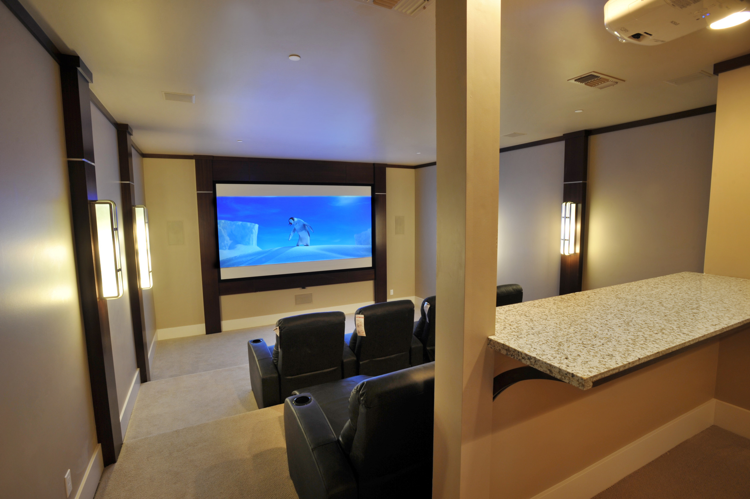 Home theater with reclining seats and a large screen